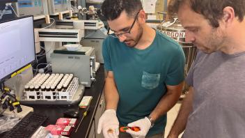 Mark Salazar, left, and Brett Poulin in lab with disposable vape pods 