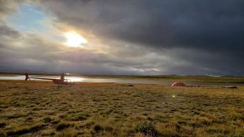 Sun peaking through the clouds on base camp on Cape Krusenstern National Monument, Alaska.