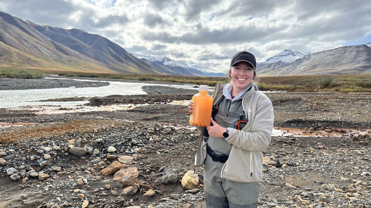 PhD Candidate Taylor Evinger sampling rivers in Alaska