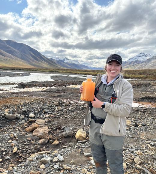 PhD Candidate Taylor Evinger sampling rivers in Alaska