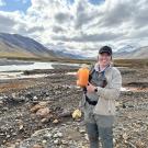 PhD Candidate Taylor Evinger sampling rivers in Alaska